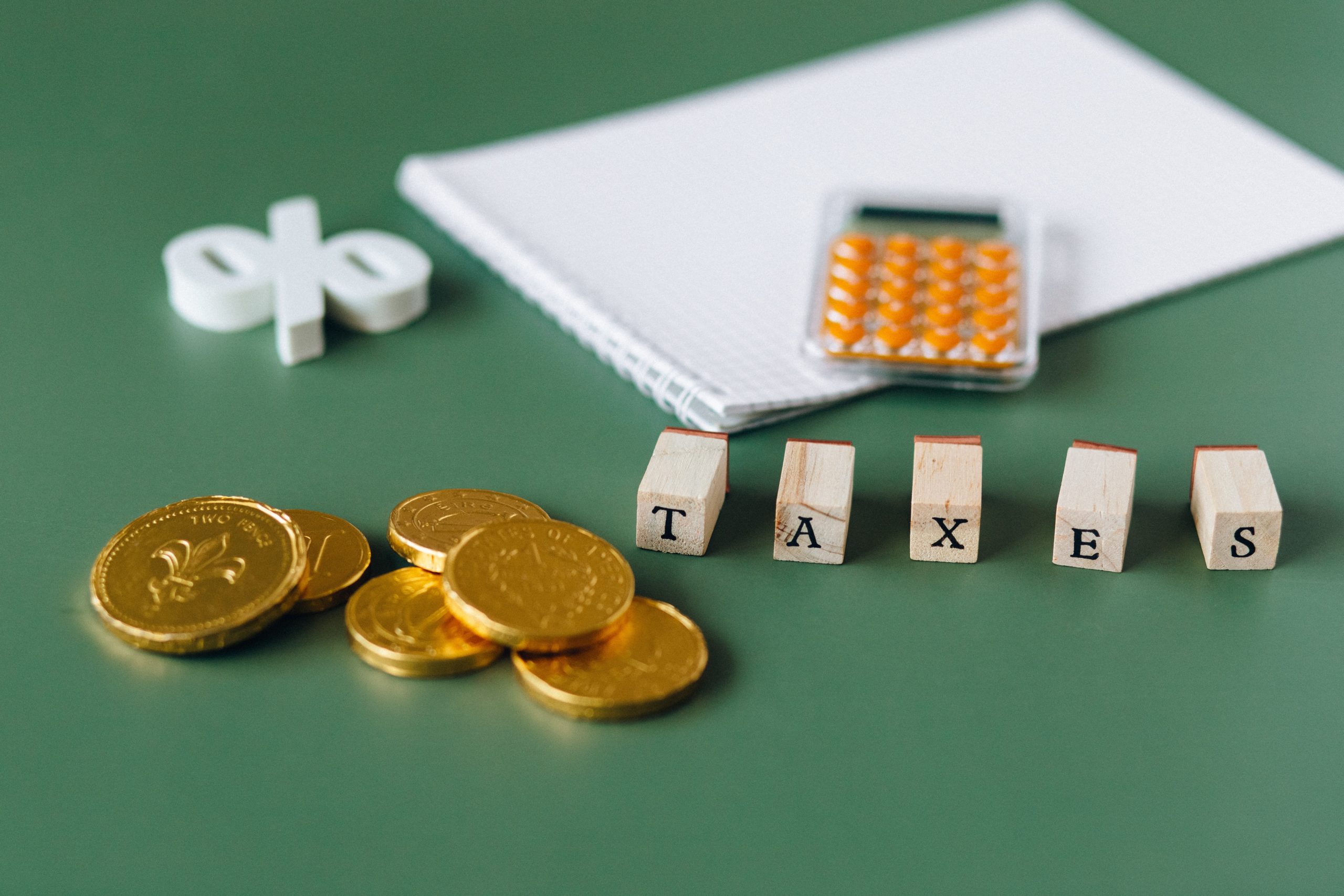 taxes written on wooden cubes and coins kept aside