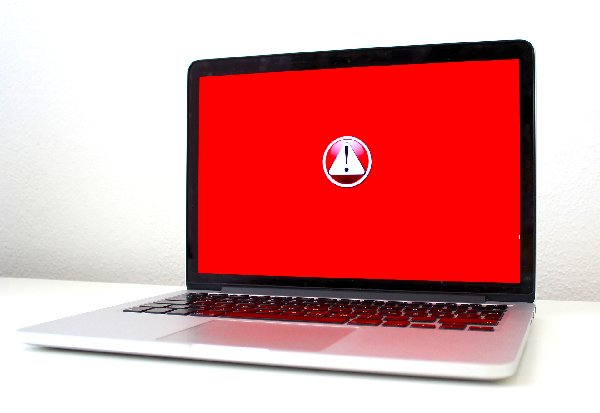 A laptop with a red screen showing an error