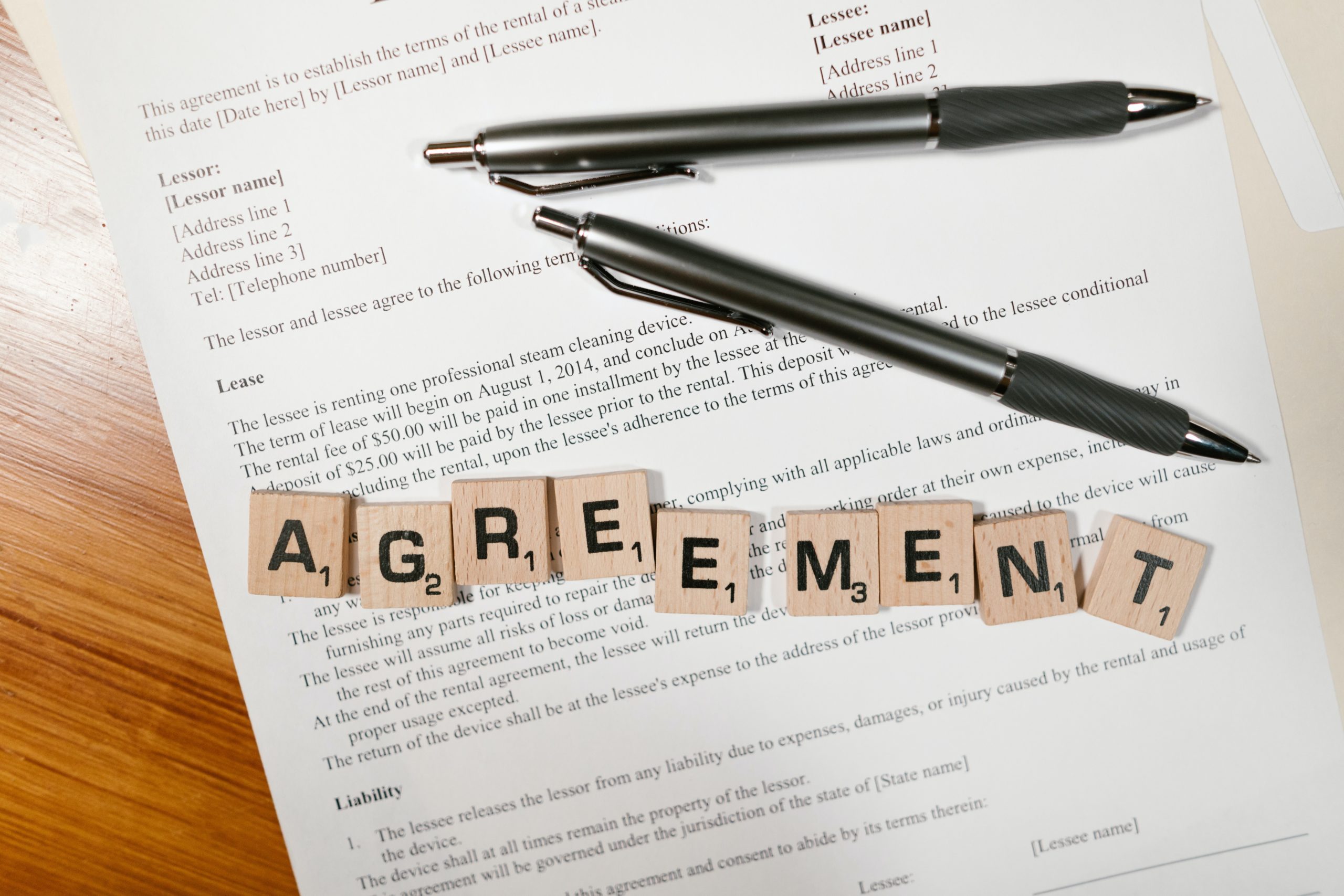 Agreement written with Scrabble blocks on an agreement document