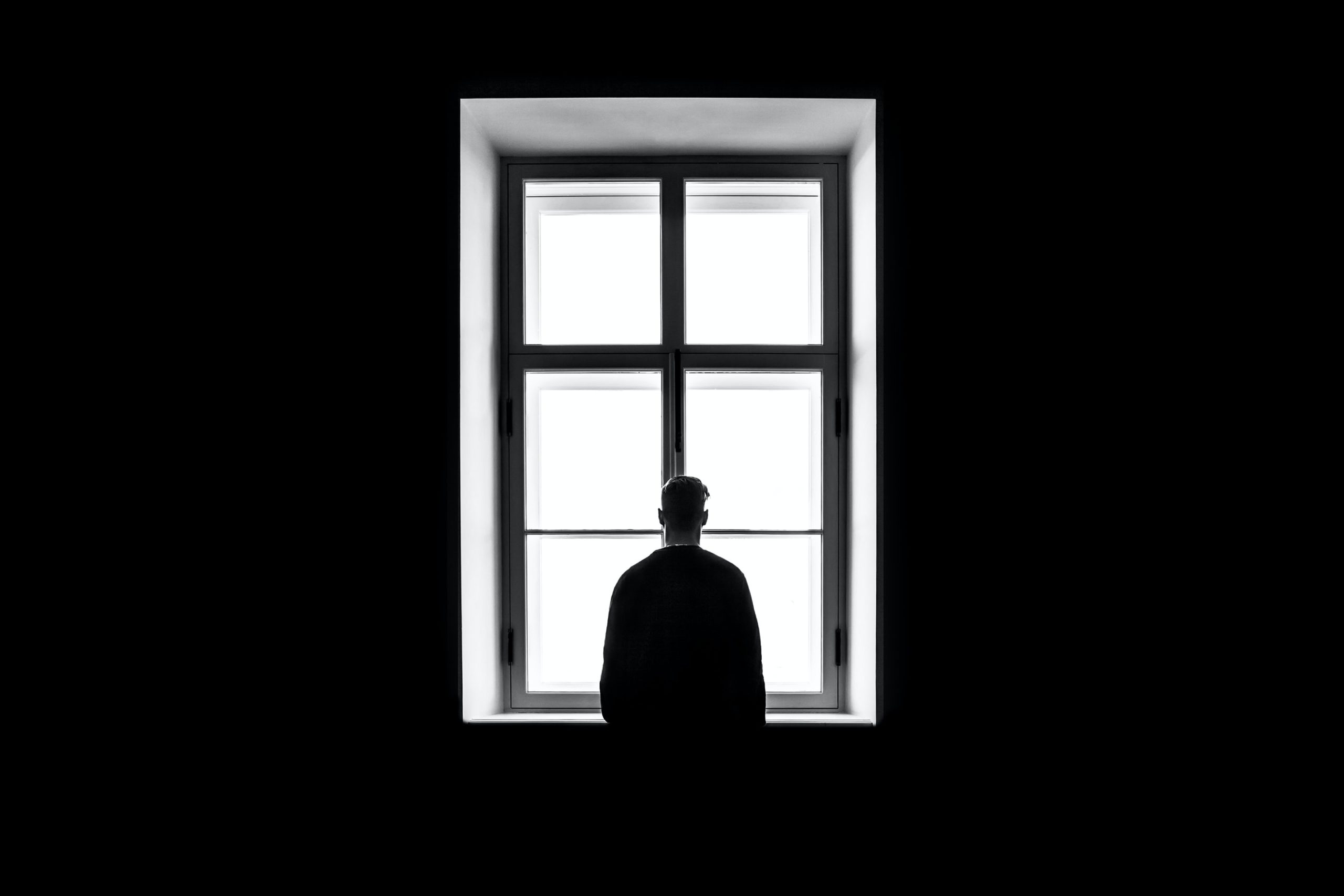 A man standing by a window