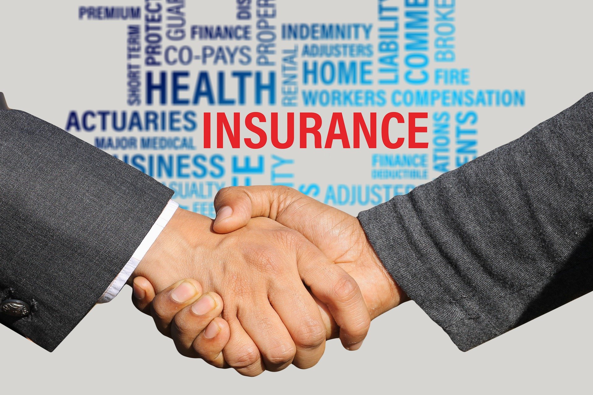 An insurer shaking hands with an entrepreneur after providing him an insurance policy