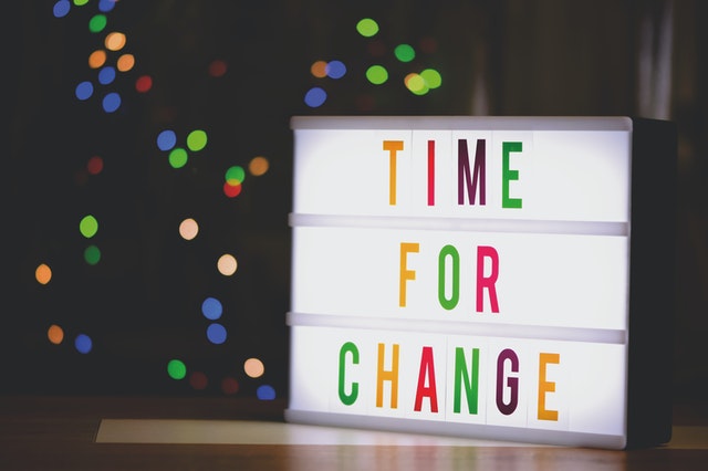 A lightbox sign that says “Time for Change” in colorful letters.
