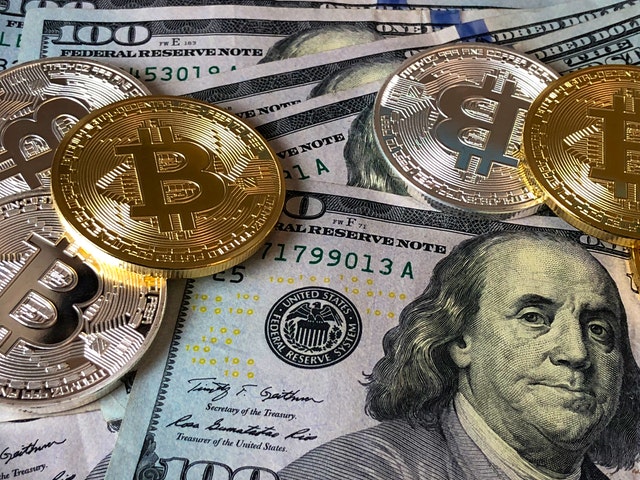 Bitcoins and U.S. dollar bills
