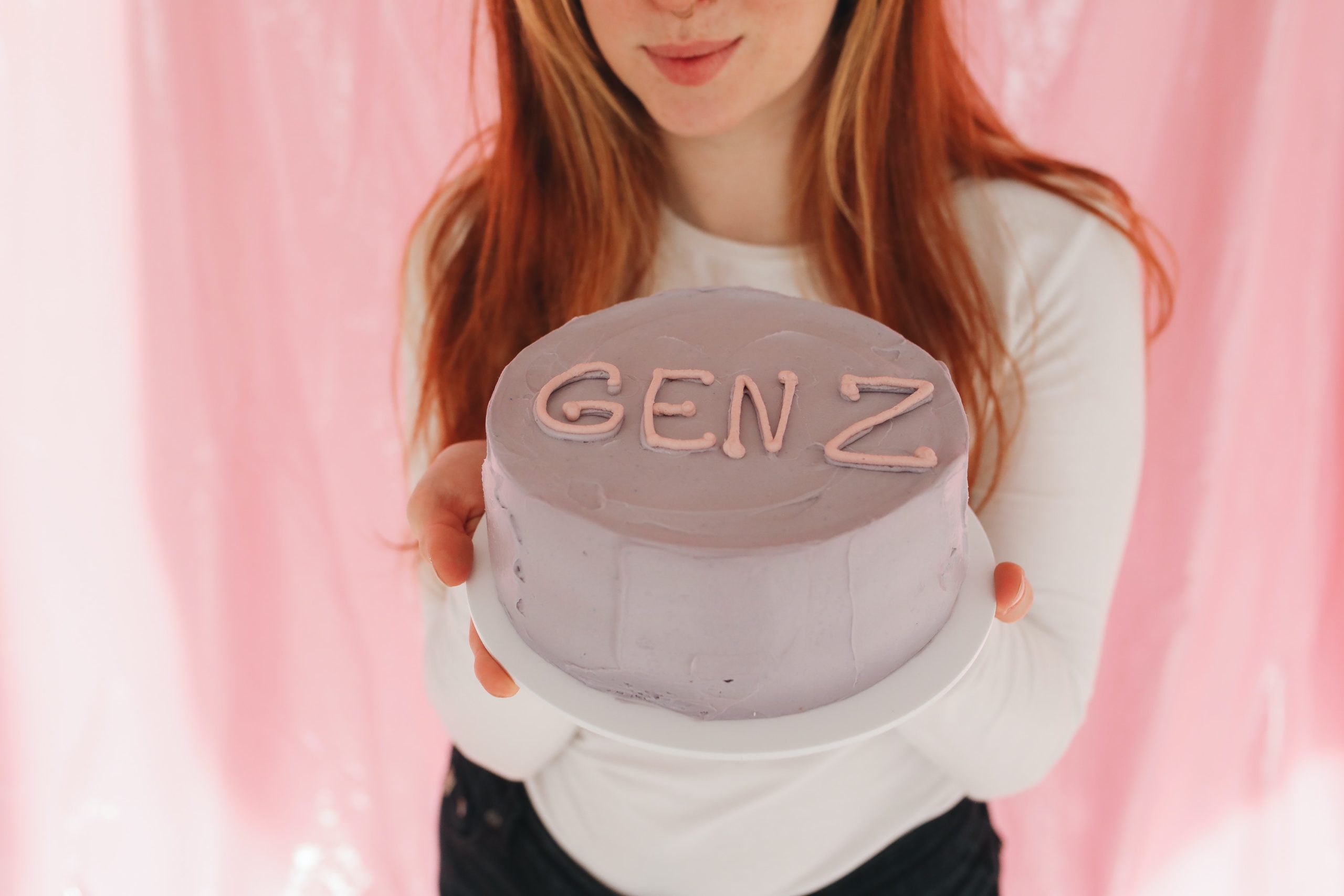 Person holding a Gen Z cake
