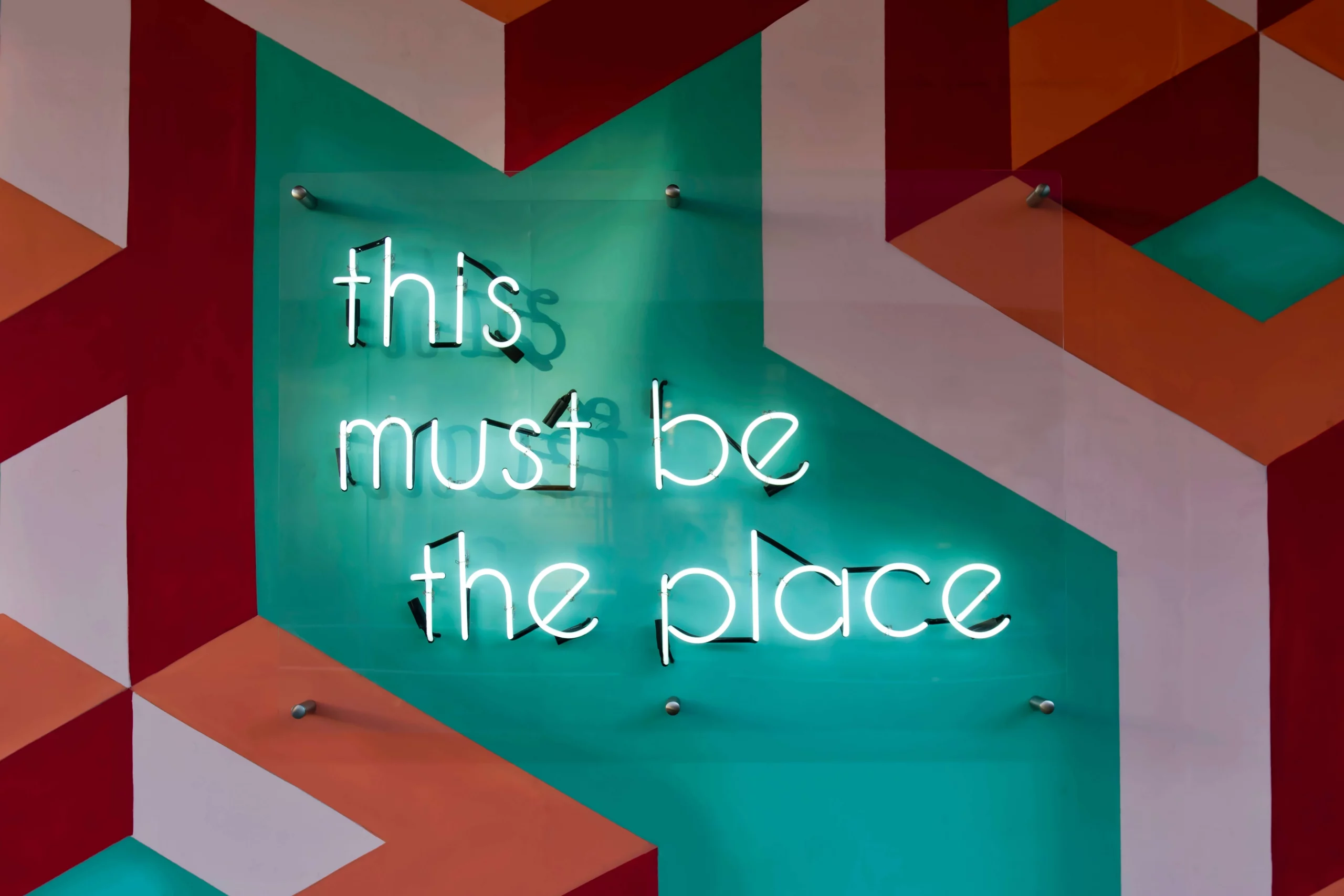 Neon sign that reads, “this must be the place.”